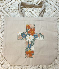 a bag with a cross on it sitting on a doily