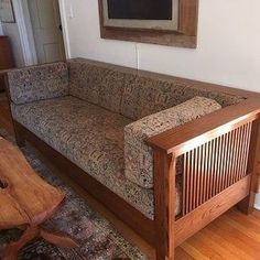 a living room filled with furniture and a painting on the wall