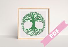 a cross stitch pattern with a tree in the middle and a pink ribbon around it