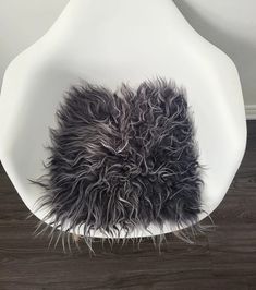 a white chair with black fur on it