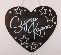 a heart shaped sign with stars and writing on it