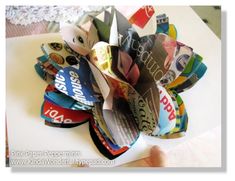 a bunch of different types of paper sitting on top of a white table next to a person's hand