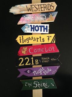 a wooden sign with many different colored signs on it's sides and the words harry potter written on them