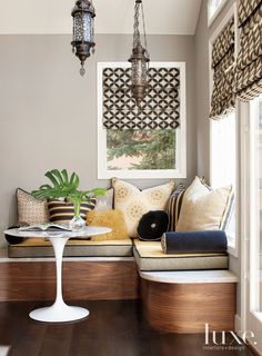 a living room filled with furniture next to a window