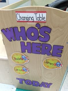 a wooden sign that says, who's here today? with stickers on it