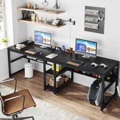 a computer desk with two computers on it