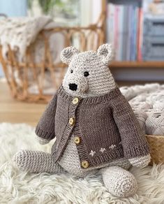 a knitted teddy bear wearing a sweater