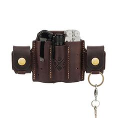 a brown leather case with two keys and a keychain hanging from it's side