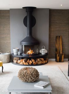 a living room filled with furniture and a fire place next to a wall mounted fireplace