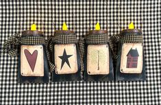 three candles are sitting on top of a black and white checkered table cloth