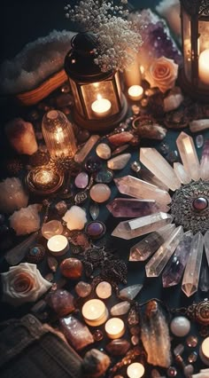 a table topped with lots of different types of stones and candles next to each other