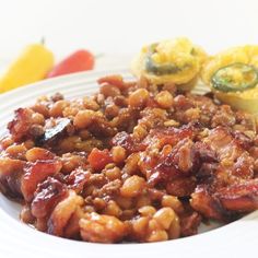 a white plate topped with meat and beans