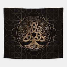 the tree of life is shown in gold on black paper with an intricate celtic design