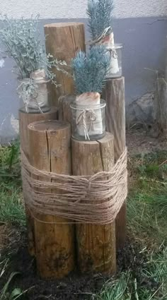 several jars are stacked on top of wooden logs