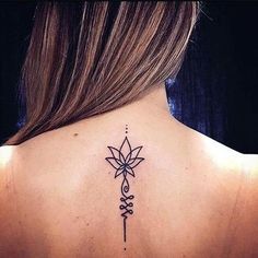 the back of a woman's neck with a tattoo on it