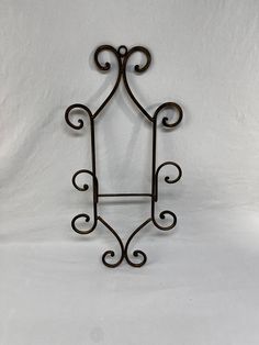 a wrought iron shelf bracket on a white background with copy space in the bottom right corner