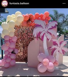 balloons and palm trees are on display at a party