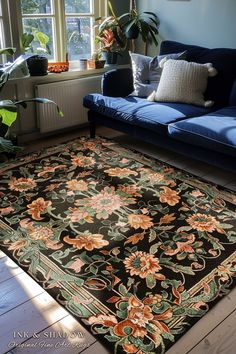 a living room with a blue couch and rug on the floor next to a window