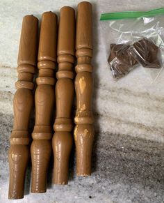 four wooden dowels sitting on top of a counter next to a package of chocolate