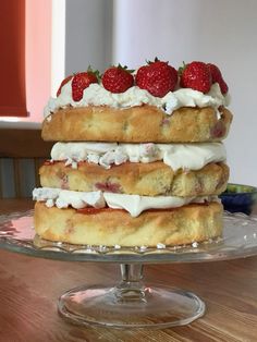 a cake with strawberries and whipped cream on top