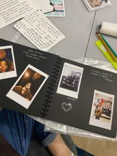 an open book with pictures and writing on it sitting on a table next to other items