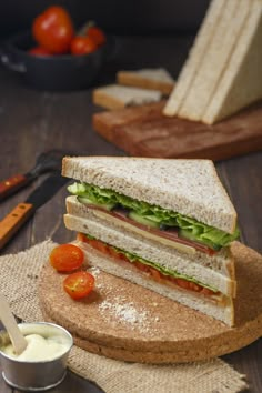 a cut in half sandwich sitting on top of a cutting board