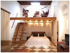 a bed sitting under a wooden ladder in a bedroom