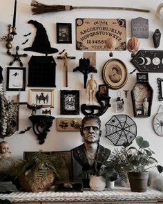 there are many pictures on the wall above the man's head and other decorations