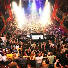 a crowd of people at a concert with their arms in the air