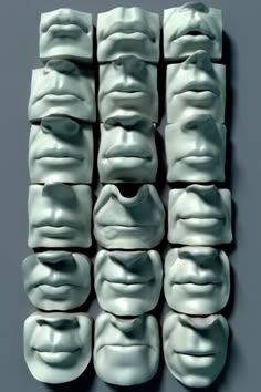 many white masks are arranged in rows on a gray background, with the faces drawn to look like human heads