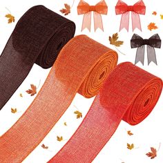 three different colors of ribbon with bows and autumn leaves around them on a white background