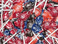 a pile of assorted candy lollipops sitting on top of each other