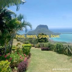 the words heal, learn, grow, love are displayed in front of an ocean view