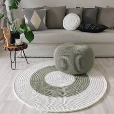 a living room filled with lots of furniture and decor on top of white flooring