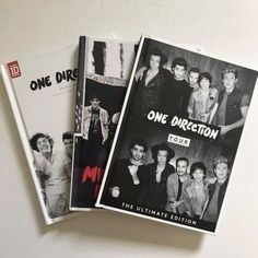 the one direction albums are stacked on top of each other in black and white photos