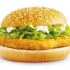 a chicken sandwich with lettuce and mayonnaise on a sesame seed bun