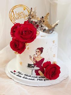 a white cake with red roses and a crown on top