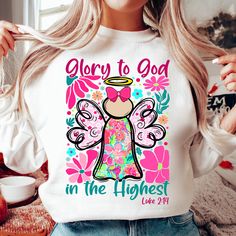 a woman wearing a t - shirt that says glory to god in the highest