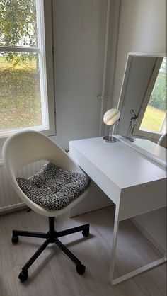 a white desk with a mirror and chair