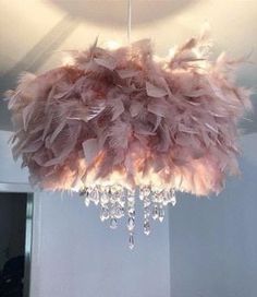 a chandelier with feathers hanging from the ceiling