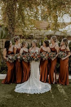 the bridesmaids are all wearing brown dresses and holding bouquets in their hands