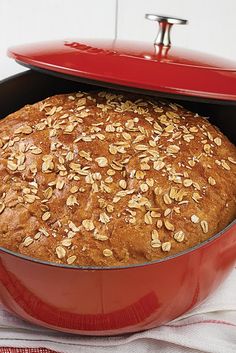 a baked bread in a red casserole dish