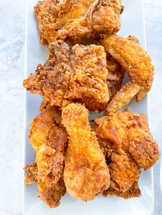 fried chicken pieces on a white plate