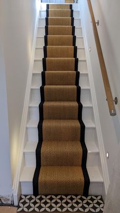 a staircase with carpeted steps and black runner