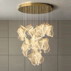 a chandelier hanging from the ceiling in a room with tiled walls and flooring