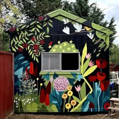 a colorful building with flowers and plants painted on it