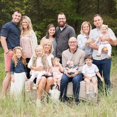 a family posing for a photo in the grass