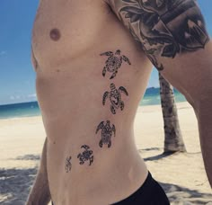 a man with a tattoo on his chest has a sea turtle design on his left side