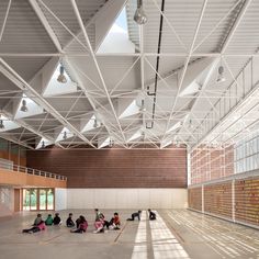 people are sitting on the floor in an empty building