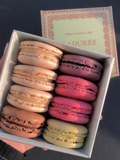 a box filled with assorted colored macaroons